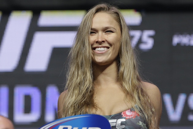 FILE - In this July 4, 2014, file photo, Ronda Rousey stands on the scale during a weigh-in for the UFC 175 mixed martial arts event at the Mandalay Bay in Las Vegas. Rousey has dominated every challenger in her two-year reign as the UFC's only women's bantamweight champion. Cat Zingano still believes she has a legitimate shot at Rousey's belt in UFC 184 on Saturday, Feb. 28, 2015, in Los Angeles. (AP Photo/John Locher, File)
