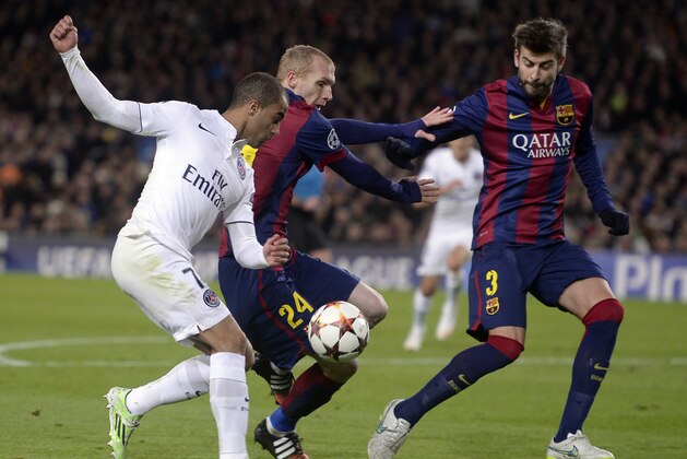 PSG's Lucas challenges for the ball with Barcelona players, Jeremy Mathieu and Gerard Pique, right, during the Group F Champions League soccer match between FC Barcelona and PSG at the Camp Nou stadium in Barcelona, Spain, Wednesday Dec. 10, 2014. (AP Photo/Manu Fernandez)