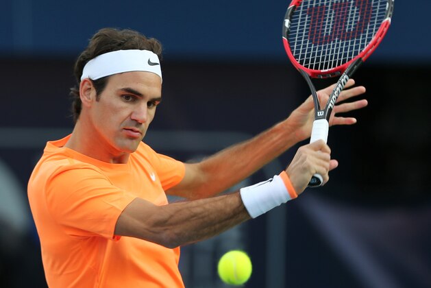 Roger Federer of Switzerland returns the ball to Borna Coric of Croatia during a semi final match of the Dubai Duty Free Tennis Championships in Dubai, United Arab Emirates, Friday, Feb. 27, 2015. (AP Photo/Kamran Jebreili)