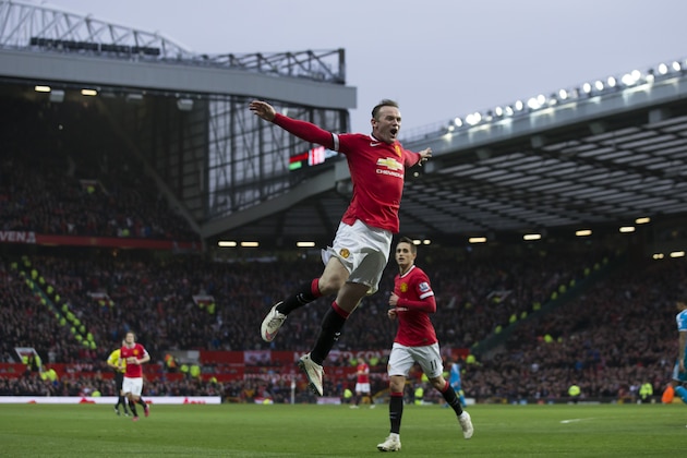 Manchester United's Wayne Rooney, center, celebrates after scoring his second goal during the English Premier League soccer match between Manchester United and Sunderland at Old Trafford Stadium, Manchester, England, Saturday Feb. 28, 2015. (AP Photo/Jon Super)