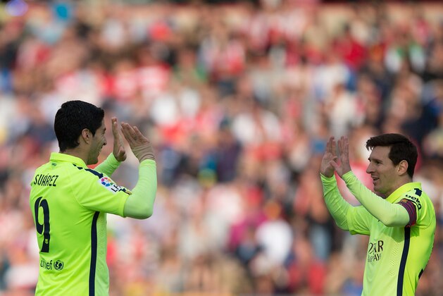 GRANADA, SPAIN - FEBRUARY 28:  Lionel Messi (R) of FC Barcelona celebrates scoring their third goal with teammate Luis Suarez (L) during the La Liga match between Granada CF and FC Barcelona at Nuevo Estadio de los Carmenes on February 28, 2015 in Granada, Spain.  (Photo by Gonzalo Arroyo Moreno/Getty Images)