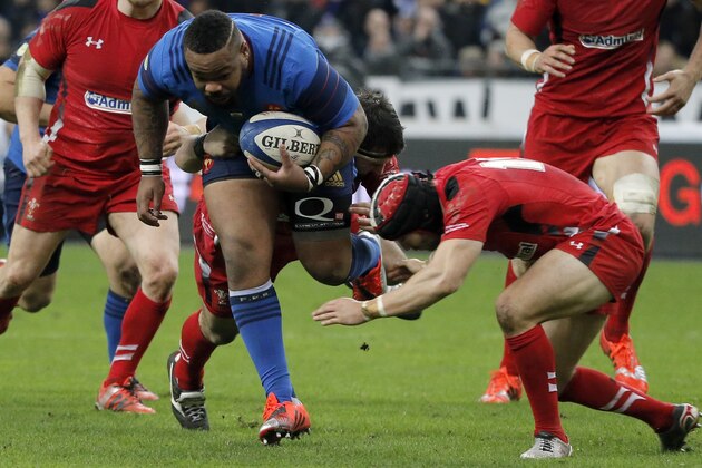 France’s Mathieu Bastareaud is tackled by Wales’ Leigh Halfpenny, right, during their Six Nations tournament match France’s against Wales at Stade de France, in Saint Denis, north of Paris, France, Saturday, Feb. 28, 2015. (AP Photo/Francois Mori)
