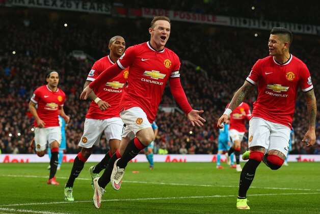 MANCHESTER, ENGLAND - FEBRUARY 28:  Wayne Rooney of Manchester United celebrates scoring the opening goal with Marcos Rojo and Ashley Young of Manchester United  during the Barclays Premier League match between Manchester United and Sunderland at Old Trafford on February 28, 2015 in Manchester, England.  (Photo by Alex Livesey/Getty Images)