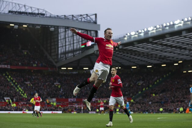 Manchester United's Wayne Rooney, center, celebrates after scoring his second goal during the English Premier League soccer match between Manchester United and Sunderland at Old Trafford Stadium, Manchester, England, Saturday Feb. 28, 2015. (AP Photo/Jon Super)