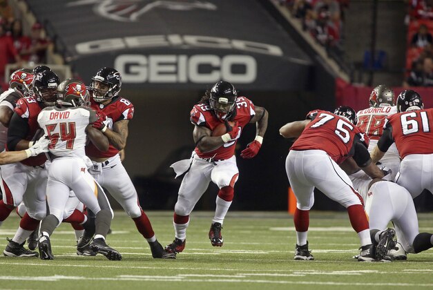 Sep 18, 2014; Atlanta, GA, USA; Atlanta Falcons running back Steven Jackson (39) runs through a hold made by guard Justin Blalock (63) and  tight end Levine Toilolo (80) and guard Jon Asamoah (75) and center Joe Hawley (61) in the first quarter of their game against the Tampa Bay Buccaneers at the Georgia Dome. The Falcons won 56-14. Mandatory Credit: Jason Getz-USA TODAY Sports