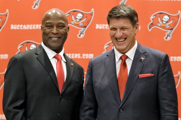 New Tampa Bay Buccaneers general manager Jason Licht, right, smiles as he poses for a photo with new head coach Lovie Smith during an NFL football news conference Thursday, Jan. 23, 2014, in Tampa, Fla. Licht becomes the fifth general manager in team history.  He takes over a team that hasn't made the playoffs since 2007. (AP Photo/Chris O'Meara)