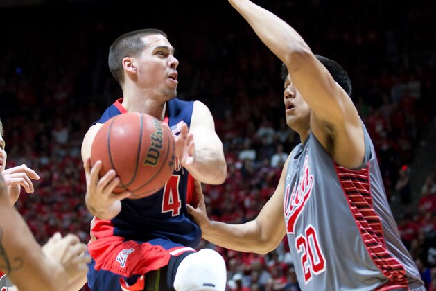 Feb 28, 2015; Salt Lake City, UT, USA; Arizona Wildcats guard T.J. McConnell (4) looks to pass the ball as Utah Utes forward Chris Reyes (20) defends during the first half at Jon M. Huntsman Center. Mandatory Credit: Russ Isabella-USA TODAY Sports