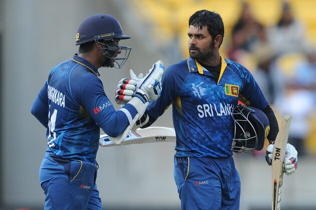 Sri Lanka's Lahiru Thirimanne, right, is congratulated by batting partner Kumar Sangakkara after scoring a century against England during their Cricket World Cup match in Wellington, New Zealand, Sunday, March 1, 2015. (AP Photo Ross Setford)