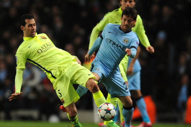 Manchester City's David Silva, left, fights for the ball with Barcelona's Sergio Busquets during the Champions League round 16 match between Manchester City and Barcelona at the Etihad Stadium, in Manchester, England, Tuesday, Feb. 24, 2015. (AP Photo/Rui Vieira)