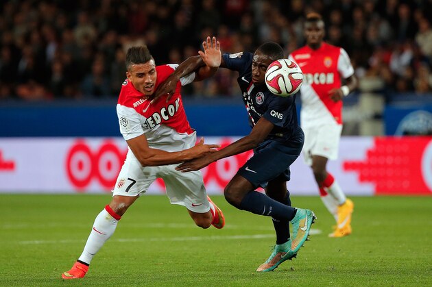 Paris Saint Germain's Blaise Matuidi, right, challenges for the ball with Monaco's Nabil Dirar, during their League One soccer match, at the Parc des Princes stadium, in Paris, France, Sunday, Oct. 5, 2014. (AP Photo/Thibault Camus)