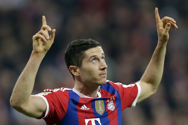 Bayern's Robert Lewandowski celebrates after scoring his side's first goal during the German first division Bundesliga soccer match between FC Bayern and Borussia Dortmund in the Allianz Arena in Munich, Germany, on Saturday, Nov. 1, 2014. (AP Photo/Matthias Schrader)