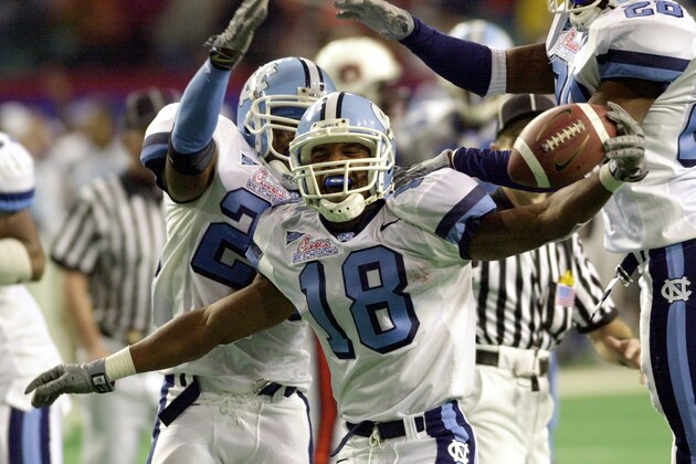 North Carolina's Michael Waddell (18) celebrates a fourth quarter interception with teammates Dexter Reid (24) and Billy-Dee Greenwood (28) against Auburn in the Peach Bowl at the Georgia Dome in Atlanta Monday, Dec. 31, 2001. North Carolina beat Auburn 16-10.  (AP Photo/Gregory Smith)
