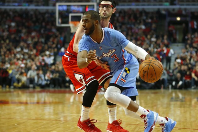 Los Angeles Clippers guard Chris Paul (3) is guarded by Chicago Bulls guard Kirk Hinrich (12) during the first half of an NBA basketball game in Chicago, on Sunday, March 1, 2015. (AP Photo/Jeff Haynes)