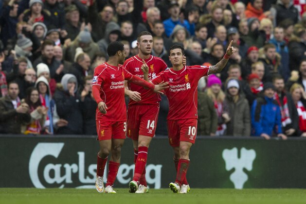Liverpool's Philippe Coutinho, right, celebrates with teammates Jordan Henderson, centre, and Raheem Sterling after scoring against Manchester City's during the English Premier League soccer match between Liverpool and Manchester City at Anfield Stadium, Liverpool, England, Sunday, March 1, 2015. Liverpool won the match 2-1. (AP Photo/Jon Super)