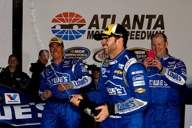 HAMPTON, GA - MARCH 01:  Jimmie Johnson, driver of the #48 Lowe's Chevrolet, celebrates with champagne in victory lane after winning the NASCAR Sprint Cup Series Folds of Honor QuikTrip 500 at Atlanta Motor Speedway on March 1, 2015 in Hampton, Georgia.  (Photo by Jerry Markland/Getty Images)