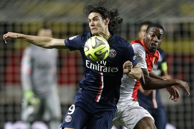 PSG's Edinson Cavani, left, challenges for the ball with Monaco's Geoffrey Kondogbia during the French League One soccer match between Monaco and Paris Saint Germain, in Monaco stadium, Sunday, March 1, 2015. (AP Photo/Lionel Cironneau)