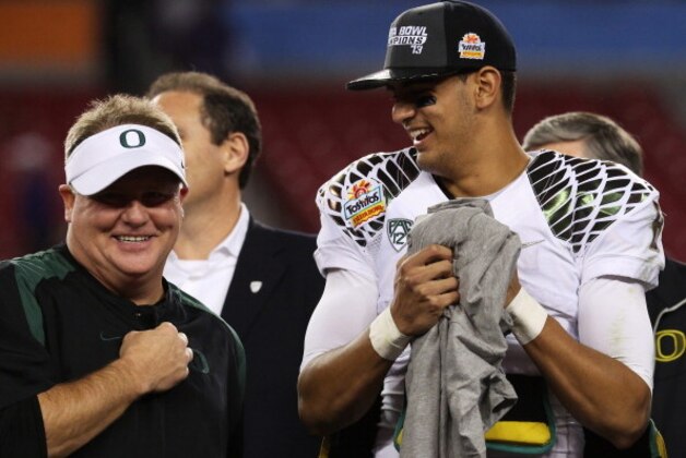 GLENDALE, AZ - JANUARY 03:  Head coach Chip Kelly celebrates with Marcus Mariota #8 of the Oregon Ducks after their 35 to 17 win over the Kansas State Wildcats in the Tostitos Fiesta Bowl at University of Phoenix Stadium on January 3, 2013 in Glendale, Arizona.  (Photo by Stephen Dunn/Getty Images)