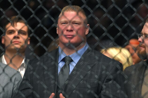 Former UFC heavyweight champion Brock Lesnar watches Ronda Rousey and Cat Zingano as they get ready to fight in a UFC 184 mixed martial arts bantamweight title bout, Saturday, Feb. 28, 2015, in Los Angeles. Rousey won after Zingano tapped out 14 seconds into the first round. (AP Photo/Mark J. Terrill)