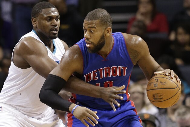 Detroit Pistons' Greg Monroe, right, drives against Charlotte Hornets' Jason Maxiell, left, during the first half of an NBA basketball game in Charlotte, N.C., Tuesday, Feb. 10, 2015. (AP Photo/Chuck Burton)