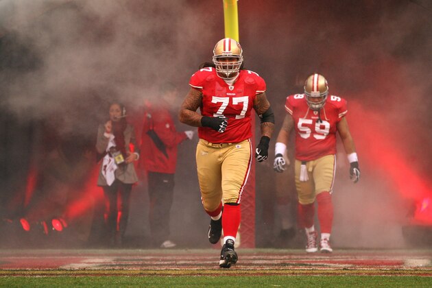 SAN FRANCISCO, CA - JANUARY 22:  Mike Iupati #77 of the San Francisco 49ers runs on the field during player introductions against the New York Giants during the NFC Championship Game at Candlestick Park on January 22, 2012 in San Francisco, California.  (Photo by Ezra Shaw/Getty Images)