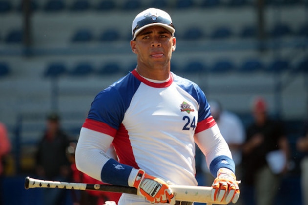 In this Nov. 12, 2014 photo, Cuban baseball player Yoan Moncada prepares for an exhibition game for major league scouts, in the Enrique Torrebiarte Stadium in Guatemala City. Yoan Moncada has arrived at the Red Sox offices, Wednesday, Feb. 25, 2015. (AP Photo/Prensa Libre)