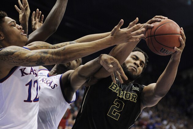 LAWRENCE, KS - FEBRUARY 14:  Rico Gathers #2 of the Baylor Bears grabs a rebound from Kelly Oubre Jr. #12 and Cliff Alexander #2 of the Kansas Jayhawks at Allen Fieldhouse on February 14, 2015 in Lawrence, Kansas. (Photo by Ed Zurga/Getty Images)