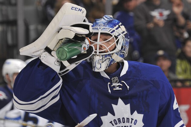 TORONTO, ON - FEBRUARY 21:  Jonathan Bernier #45 of the Toronto Maple Leafs drinks from a water bottle during NHL game action against the Winnipeg Jets February 21, 2015 at the Air Canada Centre in Toronto, Ontario, Canada. (Photo by Graig Abel/NHLI via Getty Images)