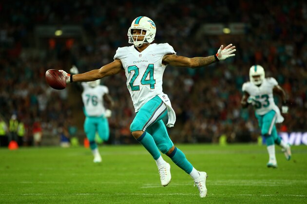 LONDON, ENGLAND - SEPTEMBER 28:  Cortland Finnegan #24 of the Miami Dolphins celebrates after returning a fumble 50 yards to score a touchdown during the NFL match between the Oakland Raiders and the Miami Dolphins at Wembley Stadium on September 28, 2014 in London, England.  (Photo by Richard Heathcote/Getty Images)