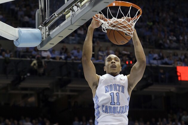 North Carolina's Brice Johnson (11) dunks as Virginia Tech's Jalen Hudson (23) looks on during the first half of an NCAA college basketball game in Chapel Hill, N.C., Sunday, Jan. 18, 2015. (AP Photo/Gerry Broome)