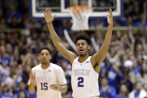 Duke's Quinn Cook (2) reacts following a basket against Syracuse as Jahlil Okafor (15) watches at rear during the first half of an NCAA college basketball game in Durham, N.C., Saturday, Feb. 28, 2015. Duke won 73-54. (AP Photo/Gerry Broome)