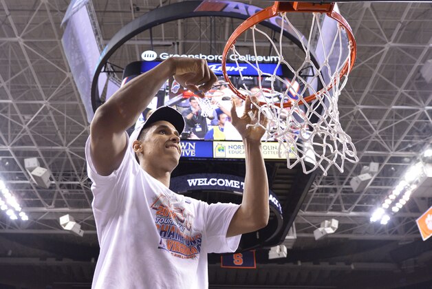 Mar 16, 2014; Greensboro, NC, USA; Virginia Cavaliers guard Malcolm Brogdon (15) cuts a piece of the net. The Cavilers defeated the Blue Devils 72-63 in the championship game of the ACC college basketball tournament at Greensboro Coliseum. Mandatory Credit: Bob Donnan-USA TODAY Sports