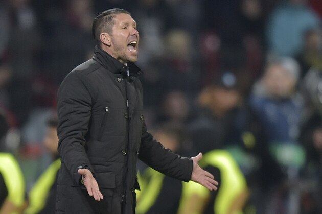 Atletico's coach Diego Simeone gestures during the Champions League round of 16 first leg soccer match between Bayer 04 Leverkusen and Atletico de Madrid on Wednesday, Feb. 25, 2015 in Leverkusen, Germany. (AP Photo/Martin Meissner)
