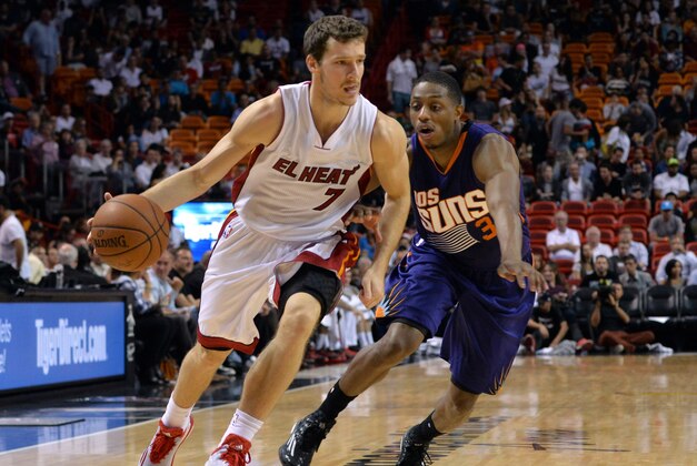 Mar 2, 2015; Miami, FL, USA; Miami Heat guard Goran Dragic (7) dribbles past Phoenix Suns guard Brandon Knight (3) during the second half at American Airlines Arena. Mandatory Credit: Steve Mitchell-USA TODAY Sports