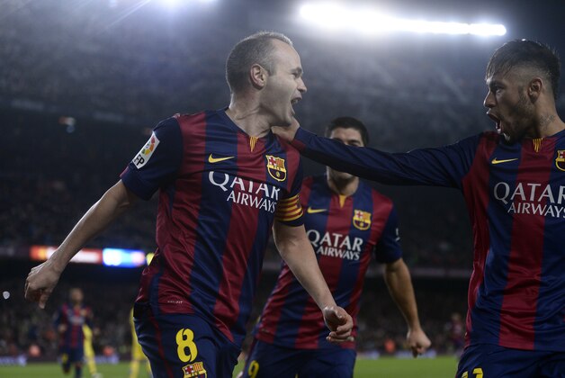 FC Barcelona's Andres Iniesta, left, reacts after scoring with his teammate Neymar, from Brazil, right, against Villarreal during a semifinal, first leg, Copa del Rey soccer match at the Camp Nou stadium in Barcelona, Spain, Wednesday, Feb. 11, 2015. (AP Photo/Manu Fernandez)