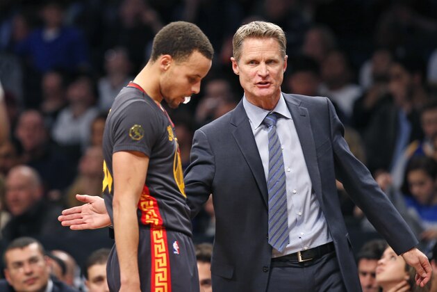 Golden State Warriors head coach Steve Kerr consoles Golden State Warriors guard Stephen Curry (30) in the second half of an NBA basketball game against the Brooklyn Nets at the Barclays Center, Monday, March 2, 2015, in New York. The Nets defeated the Warriors 110-108. (AP Photo/Kathy Willens)