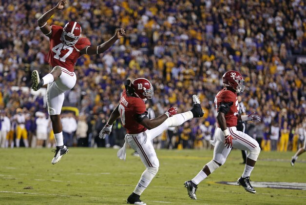 Alabama linebackers Xzavier Dickson (47), Reuben Foster (10) and lRashaan Evans (32) celebrate at the end of regulation in an NCAA college football game against LSU in Baton Rouge, La., Saturday, Nov. 8, 2014. Alabama won in overtime, 20-13. (AP Photo/Jonathan Bachman)