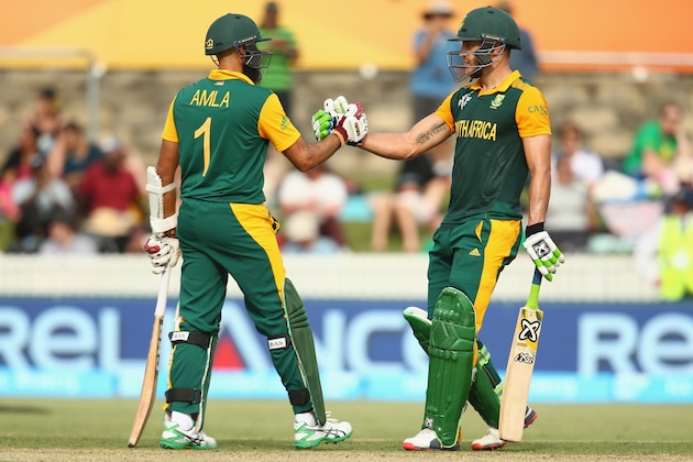 CANBERRA, AUSTRALIA - MARCH 03:  Hashim Amla and Faf du Plessis of South Africa celebrate their 200 run partnership during the 2015 ICC Cricket World Cup match between South Africa and Ireland at Manuka Oval on March 3, 2015 in Canberra, Australia.  (Photo by Mark Kolbe/Getty Images)