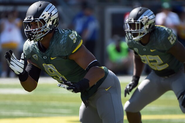Oregon defensive lineman Arik Armstead (9) rushes the quarterback during the first quarter of the college football game against the Wyoming at Autzen Stadium on Saturday, Sept. 13, 2014 in Eugene, Ore. (AP Photo/Steve Dykes)