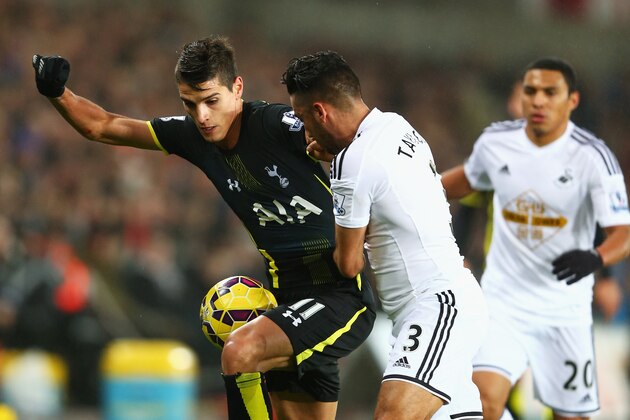 SWANSEA, WALES - DECEMBER 14: Erik Lamela of Tottenham Hotspur is held up by Neil Taylor of Swansea City during the Barclays Premier League match between Swansea City and Tottenham Hotspur at Liberty Stadium on December 14, 2014 in Swansea, Wales.  (Photo by Michael Steele/Getty Images)