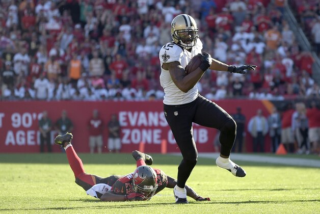 New Orleans Saints wide receiver Marques Colston (12) breaks a tackle attempt by Tampa Bay Buccaneers cornerback Leonard Johnson (29) after catching a pass and runs into the end zone for a touchdown during the second half of an NFL football game in Tampa, Fla., Sunday, Dec. 28, 2014. The Saints won 23-20.(AP Photo/Phelan M. Ebenhack)