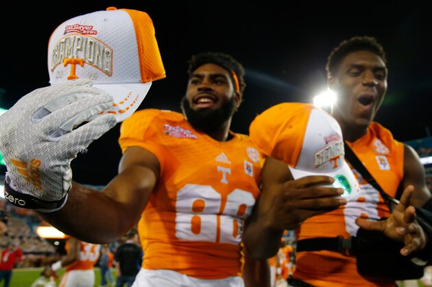 JACKSONVILLE, FL - JANUARY 02:  Tennessee Volunteers players celebrate following the TaxSlayer Bowl against the Iowa Hawkeyes at EverBank Field on January 2, 2015 in Jacksonville, Florida.  The Tennessee Volunteers defeated the Iowa Hawkeyes 45-28.  (Photo by Sam Greenwood/Getty Images)