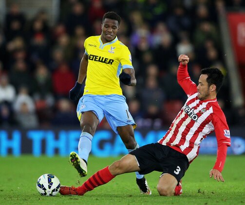 SOUTHAMPTON, ENGLAND - MARCH 03:  Wilfried Zaha of Crystal Palace is tackled by Maya Yoshida of Southampton during the Barclays Premier League match between Southampton and Crystal Palace at St Mary's Stadium on March 3, 2015 in Southampton, England.  (Photo by Paul Gilham/Getty Images)