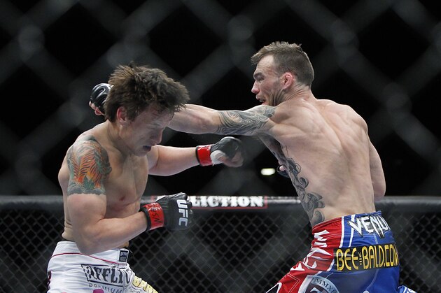 May 25, 2013; Las Vegas, NV, USA; George Roop punches Brian Bowles during UFC 160 at the MGM Grand Garden Arena. Mandatory Credit: Gary A. Vasquez-USA TODAY Sports