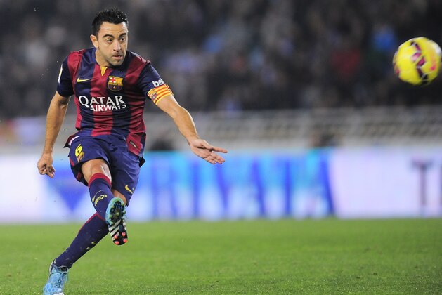 Barcelona's Xavi Hernandez, kicks the ball during their La Liga soccer match between Real Sociedad and Barcelona, at Anoeta stadium in San Sebastian, northern Spain, Sunday, Jan.4, 2015. Barcelona lost the match 1-0. (AP Photo/Alvaro Barrientos)