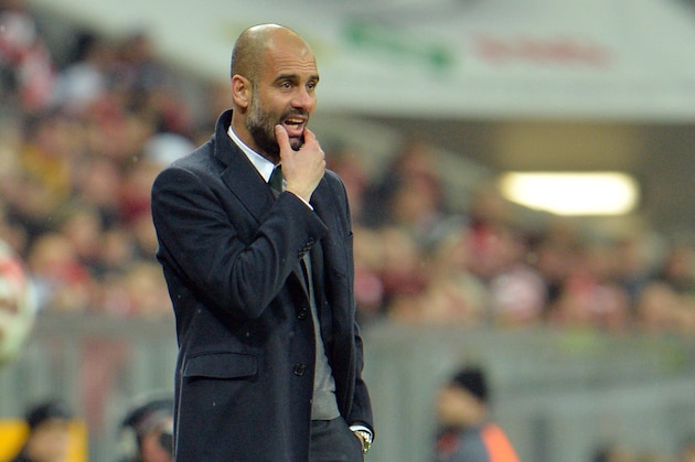 Munich head coach Pep Guardiola watches from the sideline during the soccer match between FC Bayern Munich and 1. FC Cologne in the Allianz Arena in Munich, Germany, Friday, Feb. 27, 2015. (AP Photo/Kerstin Joensson)
