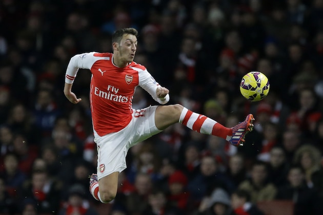 Arsenal's Mesut Ozil controls the ball during the English Premier League soccer match between Arsenal and Leicester City at the Emirates Stadium in London, Tuesday, Feb. 10, 2015.  (AP Photo/Matt Dunham)