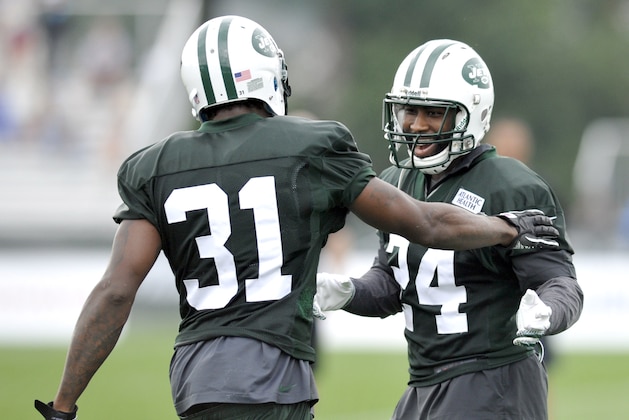 New York Jets cornerbacks Darrelle Revis (24) and Antonio Cromartie celebrate at their NFL football training camp Saturday, July 28, 2012, in Cortland, N.Y. (AP Photo/Bill Kostroun)