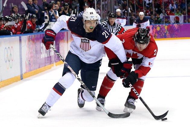 SOCHI, RUSSIA - FEBRUARY 21:  James van Riemsdyk #21 of the United States challenges Duncan Keith #2 of Canada for the puck during the Men's Ice Hockey Semifinal Playoff on Day 14 of the 2014 Sochi Winter Olympics at Bolshoy Ice Dome on February 21, 2014 in Sochi, Russia.  (Photo by Bruce Bennett/Getty Images)