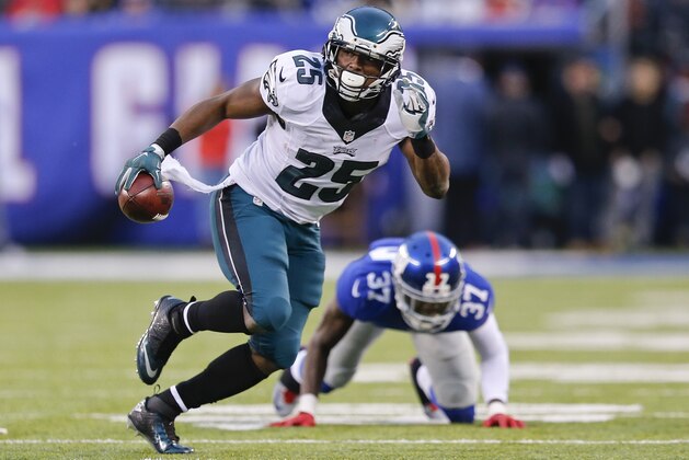 Philadelphia Eagles' LeSean McCoy (25) runs away from New York Giants' Mike Harris (37) during the second half of an NFL football game Sunday, Dec. 28, 2014, in East Rutherford, N.J. (AP Photo/Julio Cortez)