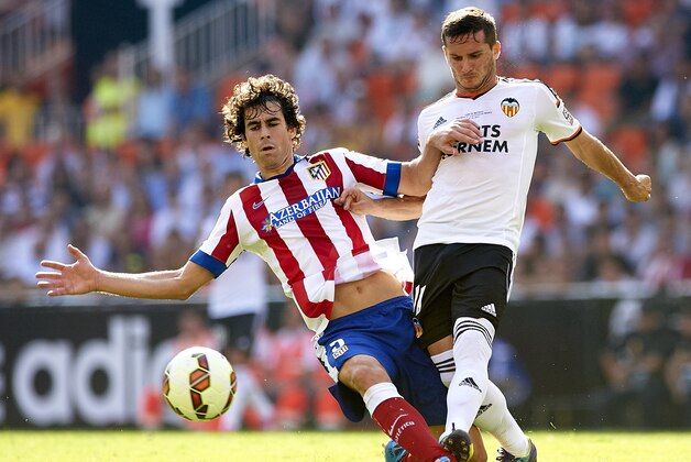VALENCIA, SPAIN - OCTOBER 04:  Pablo Piatti (R) of Valencia is tackled by Tiago Cardoso of Atletico de Madrid during the La Liga match between Valencia CF and Club Atletico de Madrid at Estadi de Mestalla on October 4, 2014 in Valencia, Spain.  (Photo by Manuel Queimadelos Alonso/Getty Images)
